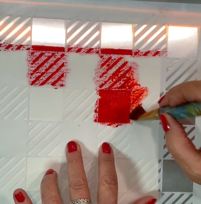 Place a plaid stencil over a SmArt sheet. Paint with red edible color. Spray the back of the SmArt sheet with Paper Potion. Drape it over a cake of your choice. Add the burger, hot dog and corn to the top.